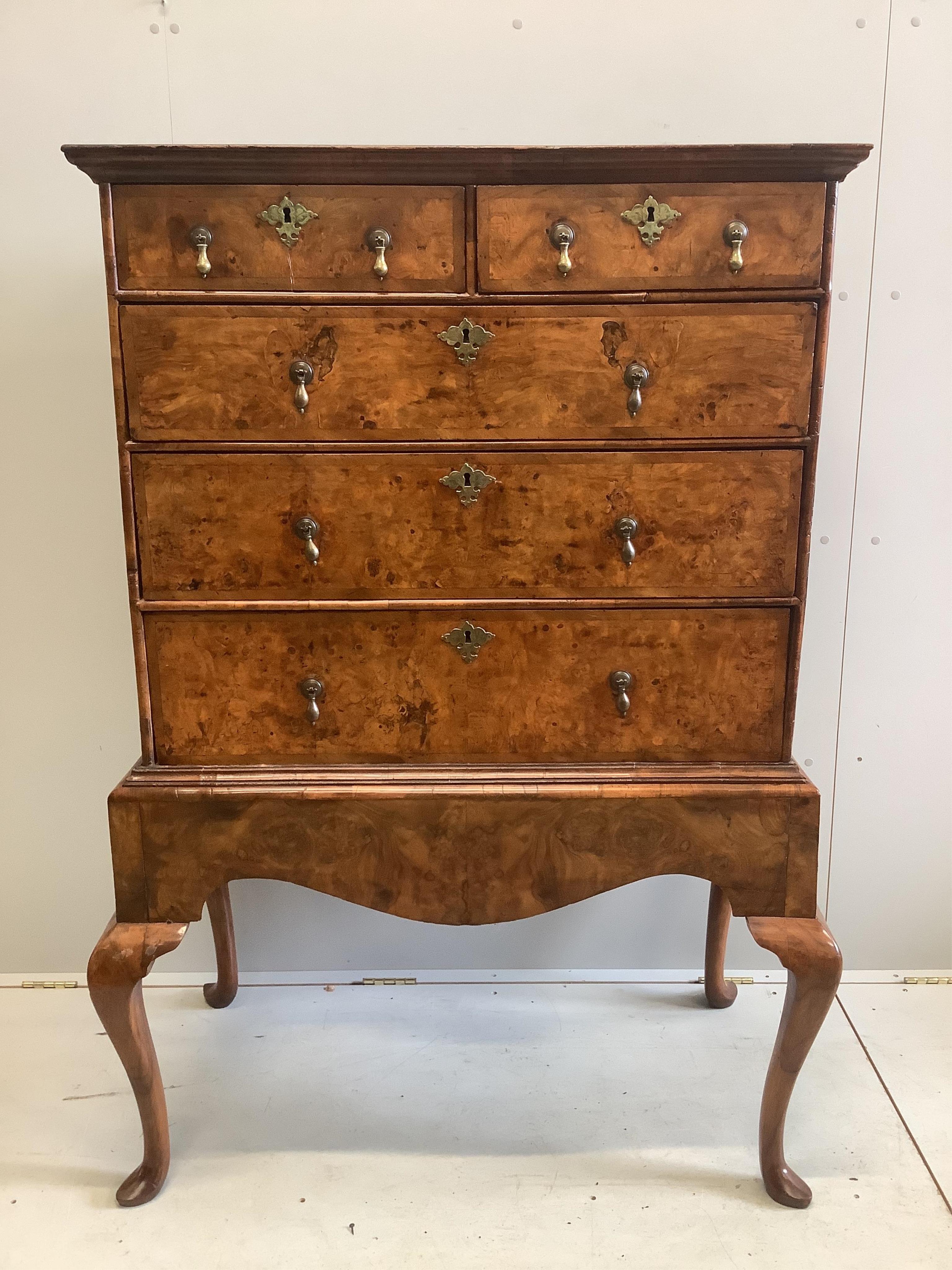 An early 18th century walnut chest on stand, width 98cm, depth 53cm, height 148cm. Condition - fair to good